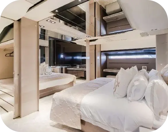 Bridgetown guest cabin with a large double bed in white linen, pale wood panelling and mirrored panels
