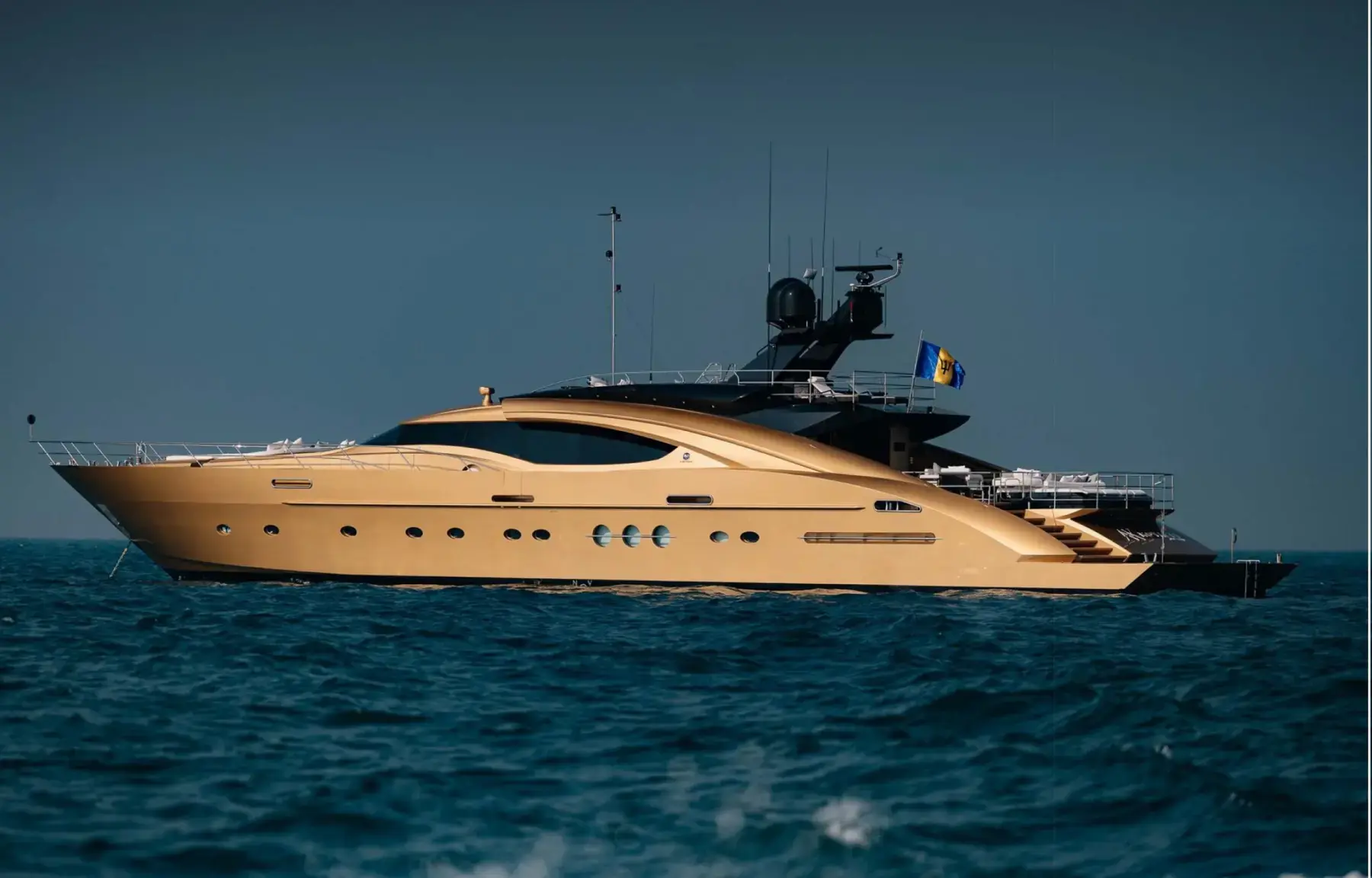 AK Royalty, a 42 m Palmer Johnson superyacht with a gold hull, at sea