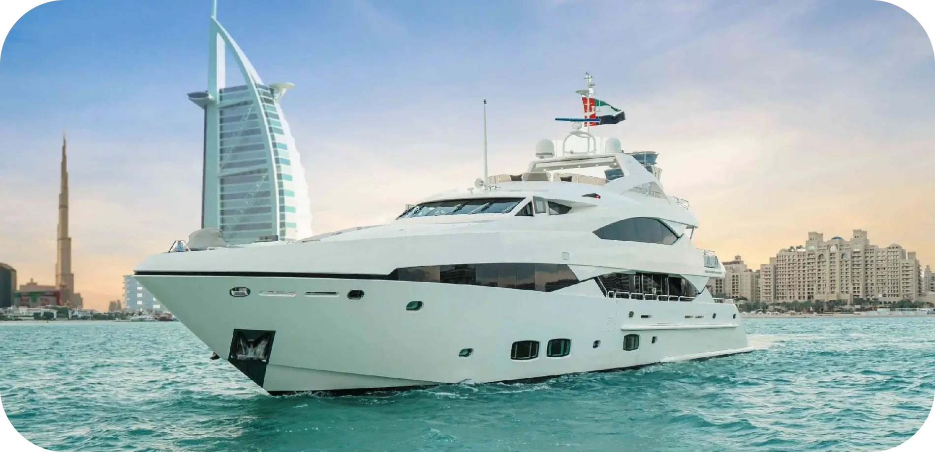 Side view of Liquid Asset, a white Sunseeker with dark tinted windows on three decks, cruising past the Burj Al Arab