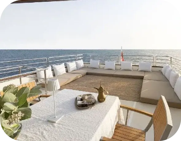 Melody 2 open deck with low cushioned seating around a woven rug, and a table set with a brass Arabic coffee pot