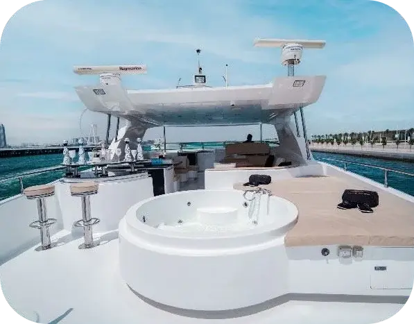 Sea Breeze flybridge with a round spa tub, a bar counter with stools and a cushioned sunpad under a white hardtop