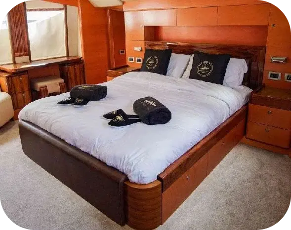 Sea Breeze guest cabin with a double bed, timber panelling, towels and slippers laid out, and a dressing table by the window