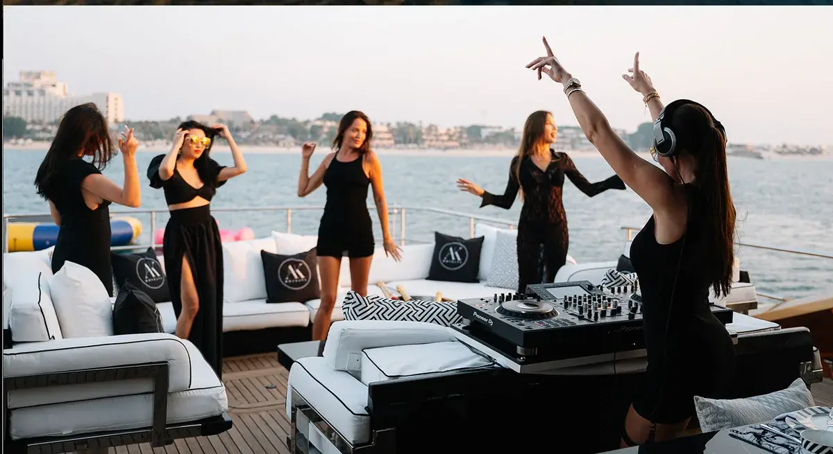 A DJ playing on the open aft deck of AK Royalty