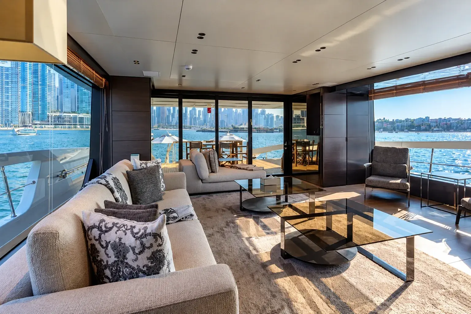 Illustration of the Lorenzo main-deck lounge, with linen sofas, glass tables and tall windows onto the water